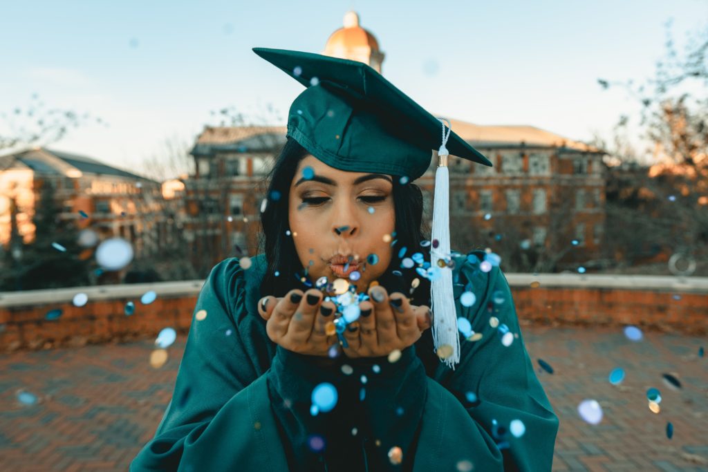 university giving days: featured image of young girl in cap and gown with confetti